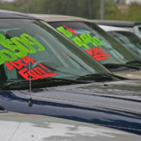 Buyback cars with price on windshield in lot