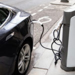 Electric Car with Charging Cable attached to it Electric Car with Charging Cable attached to it