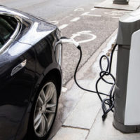 Electric Car with Charging Cable attached to it Electric Car with Charging Cable attached to it