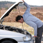 Man looking inside a salvage vehicle Man looking inside a salvage vehicle