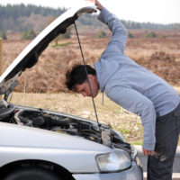 Man looking at engine of car Man looking at engine of car