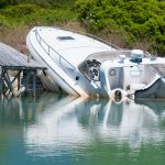 Speedboat beached and partially sunk at it's mooring