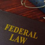 Book with title federal law on a table. Book with title federal law on a table.